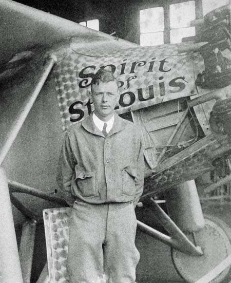 Charles Lindbergh poses in front of the Spirit of St. Louis.
